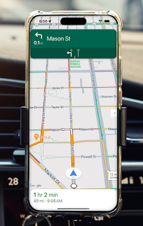 Mobile phone on a dashboard showing Google Maps navigation