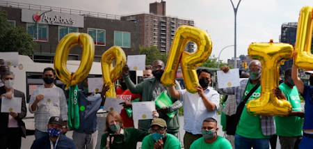 Employees from The Driver's Cooperative holding up balloons