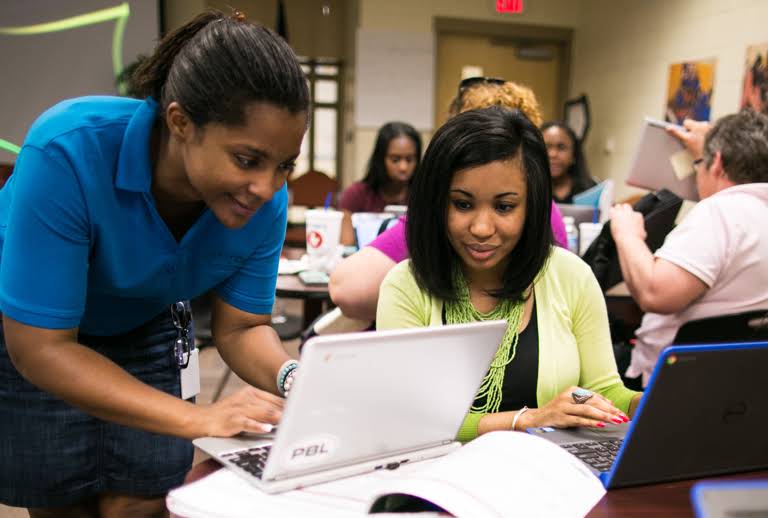 Two women looking at a laptop