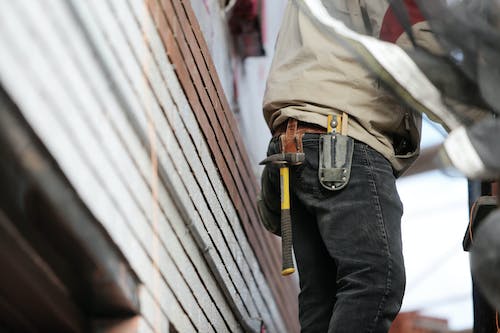 Free Man Wearing Black Denim Pants With Carrying Hammer on Holster Stock Photo