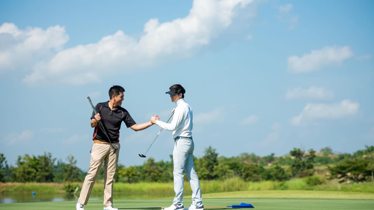 Golfers High-Fiving.