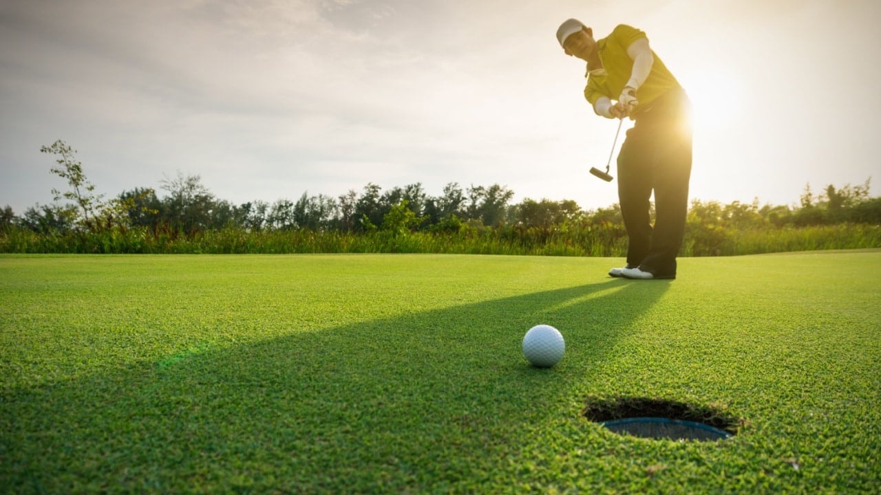 Golfer Putting On A Green.