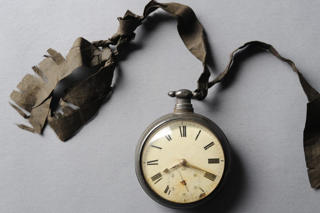 a vintage watch on a weathered ribbon