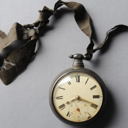 a vintage watch on a weathered ribbon