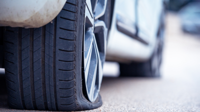 Close-up image of a car's flat rear tire