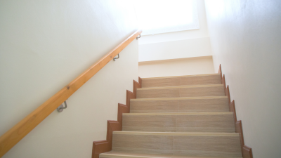 looking up staircase in home with bright window at top