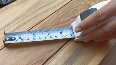 tape measure being used on wood furniture