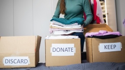 person sorting stuff into different boxes