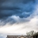 Storm clouds over suburban home