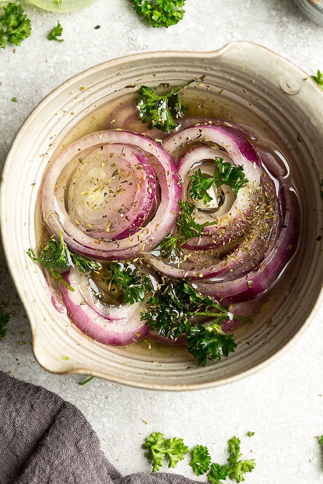 Overhead photo of easy pickled onions garnished with parsley.