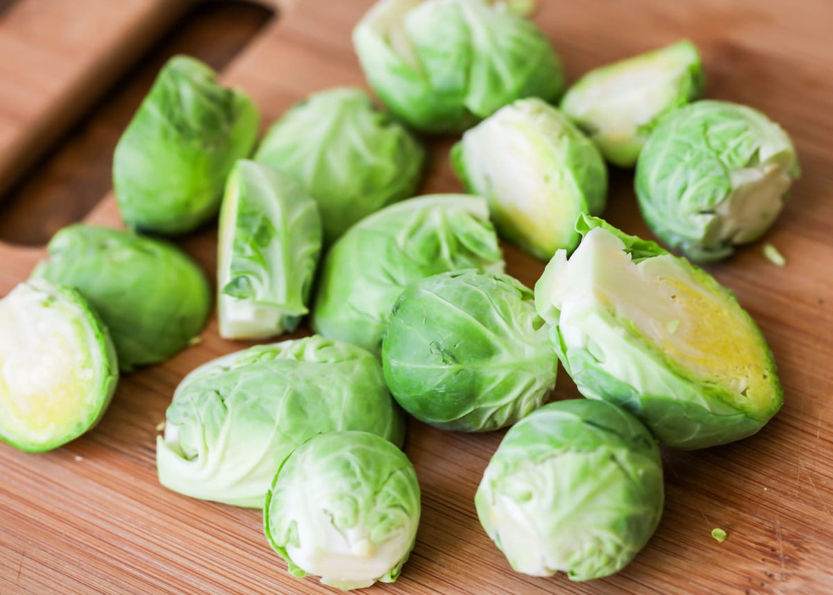 Halved brussels sprouts on cutting board.