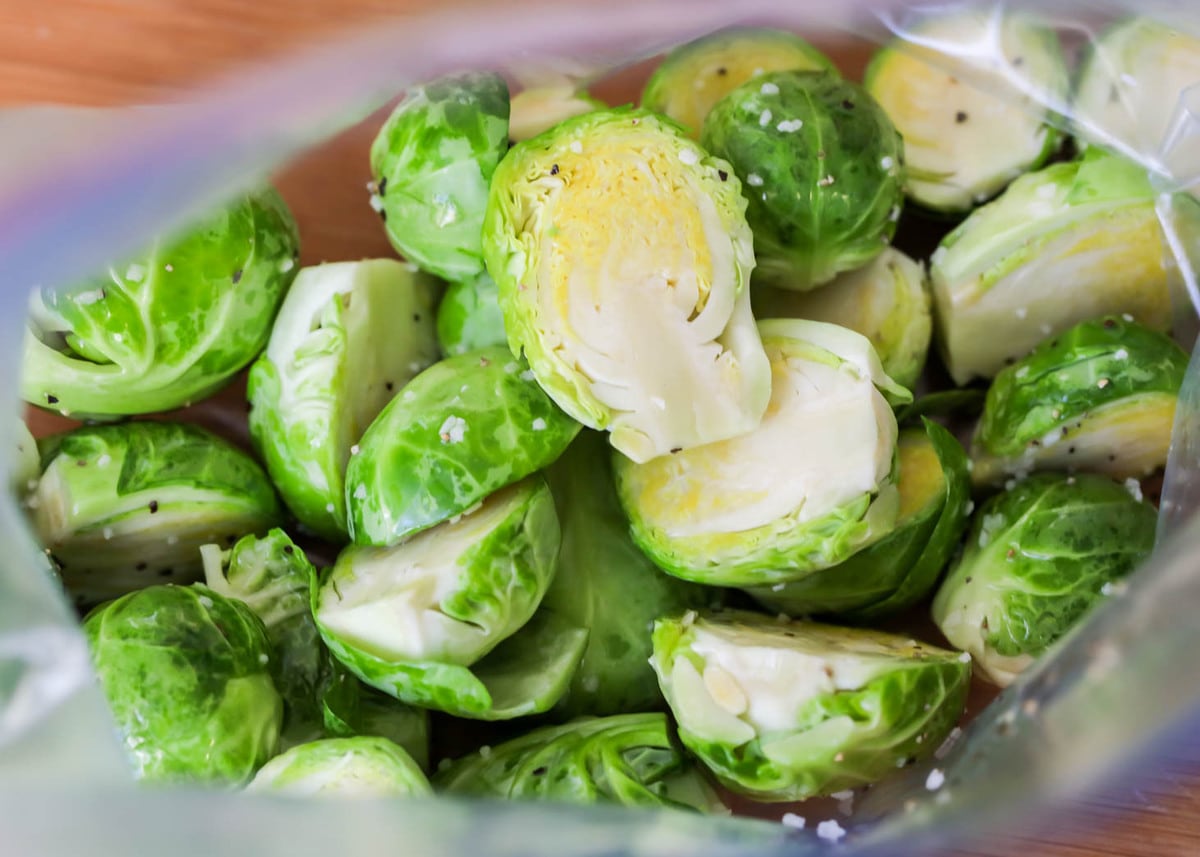 Brussel sprouts prepped in bag with oil and salt.