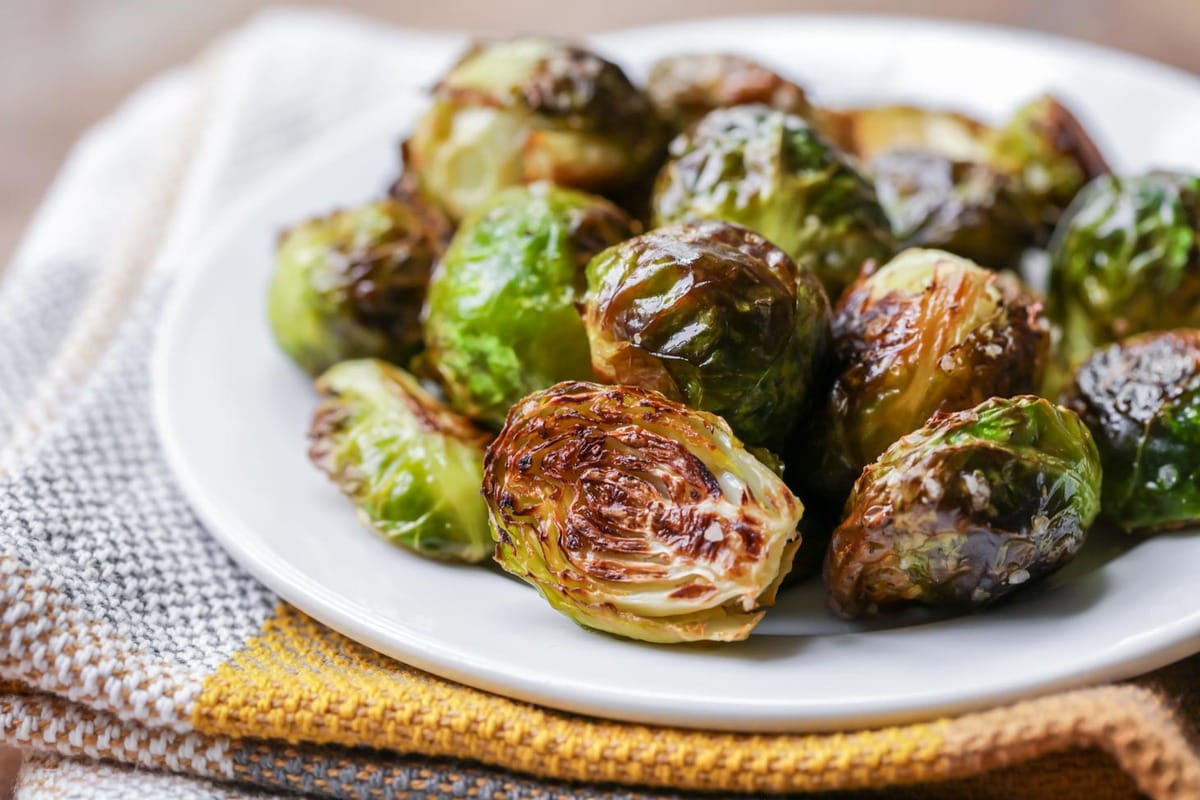 Roasted Brussel sprouts recipe served on white plate.