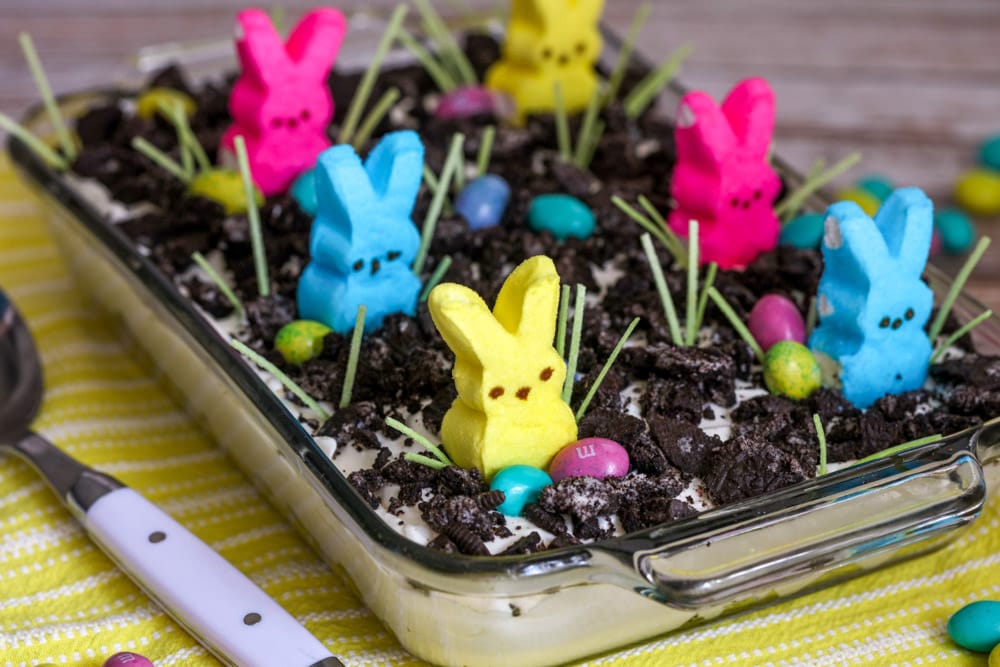 Easter Dirt Cake topped with Oreos and colored peeps.