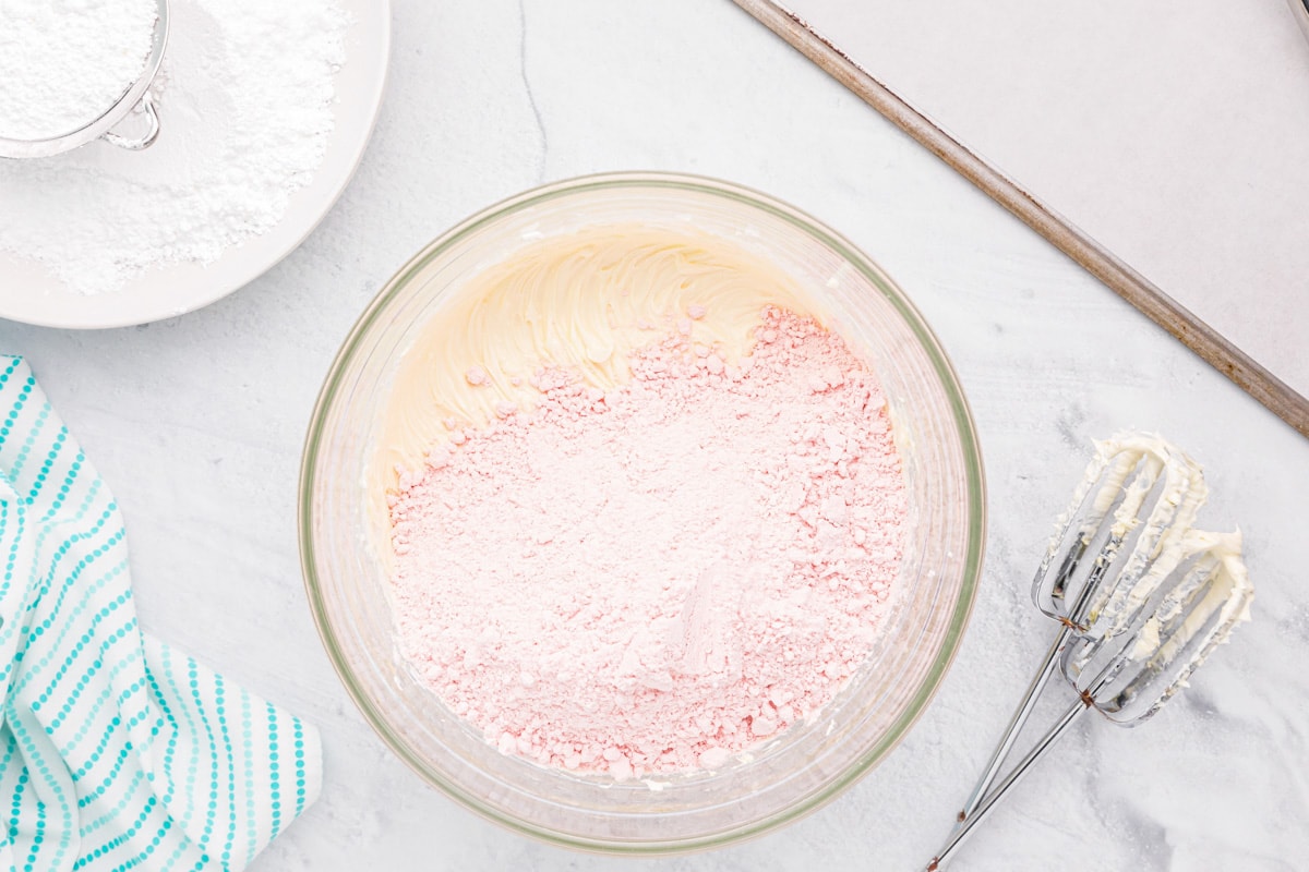 Ingredients mixed in a glass bowl for strawberry cake mix cookies.