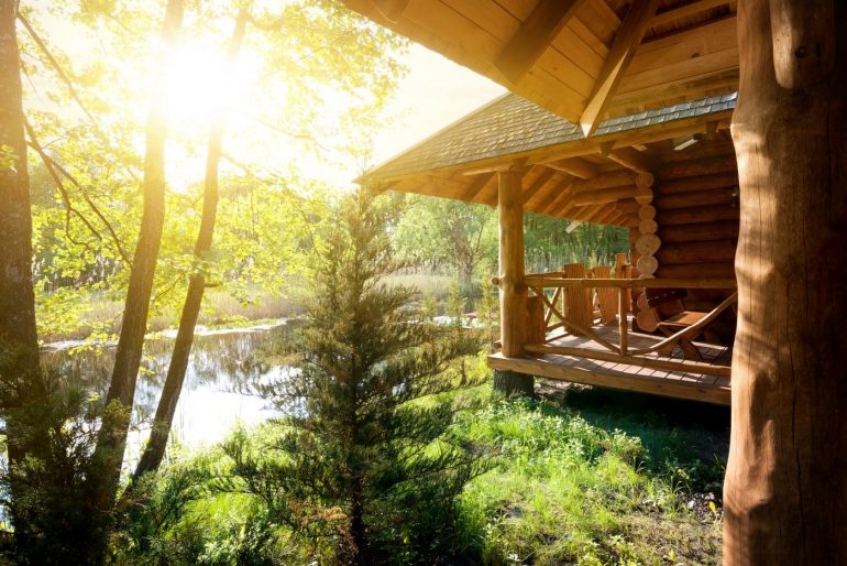 Log cabin and lake at sunrise