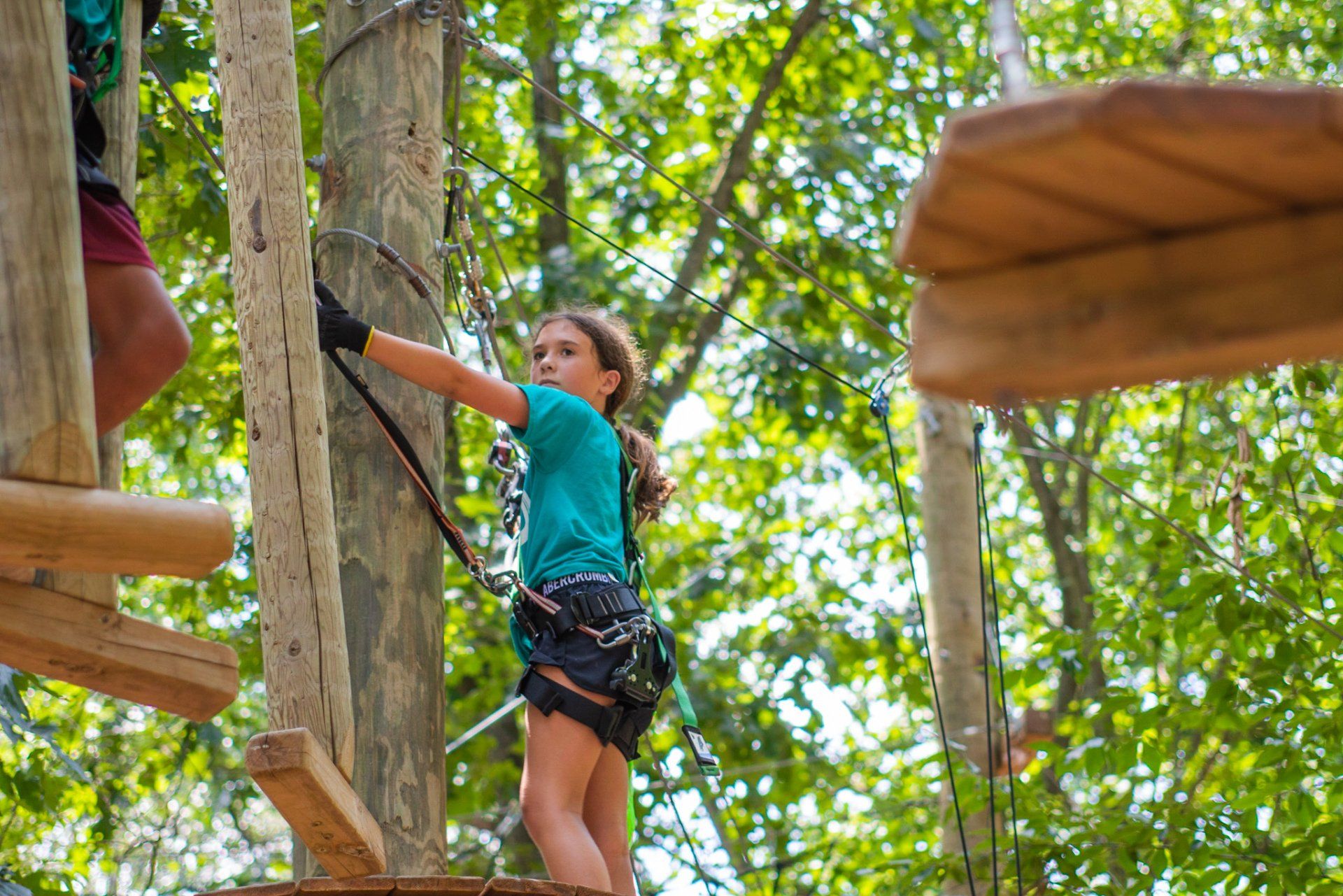 camp child climbing high ropes course