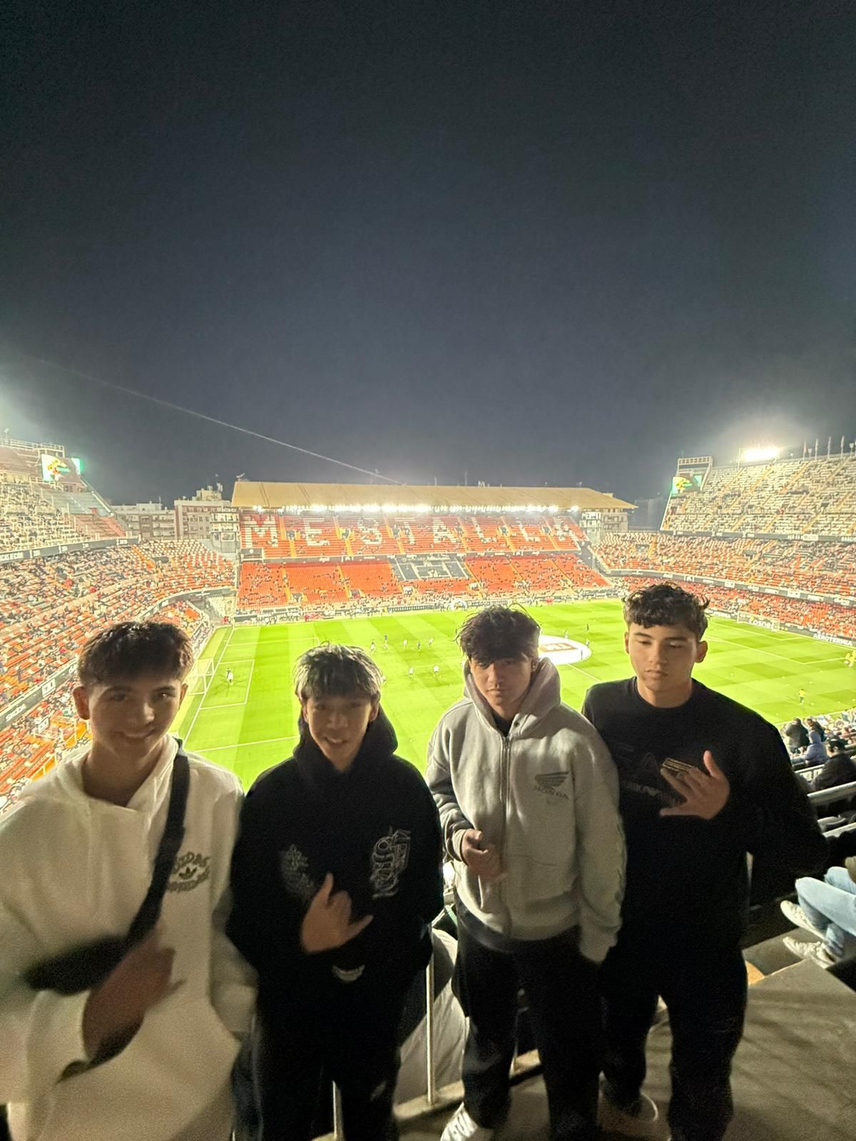 hawaiian boys in a spanish soccer stadium at night