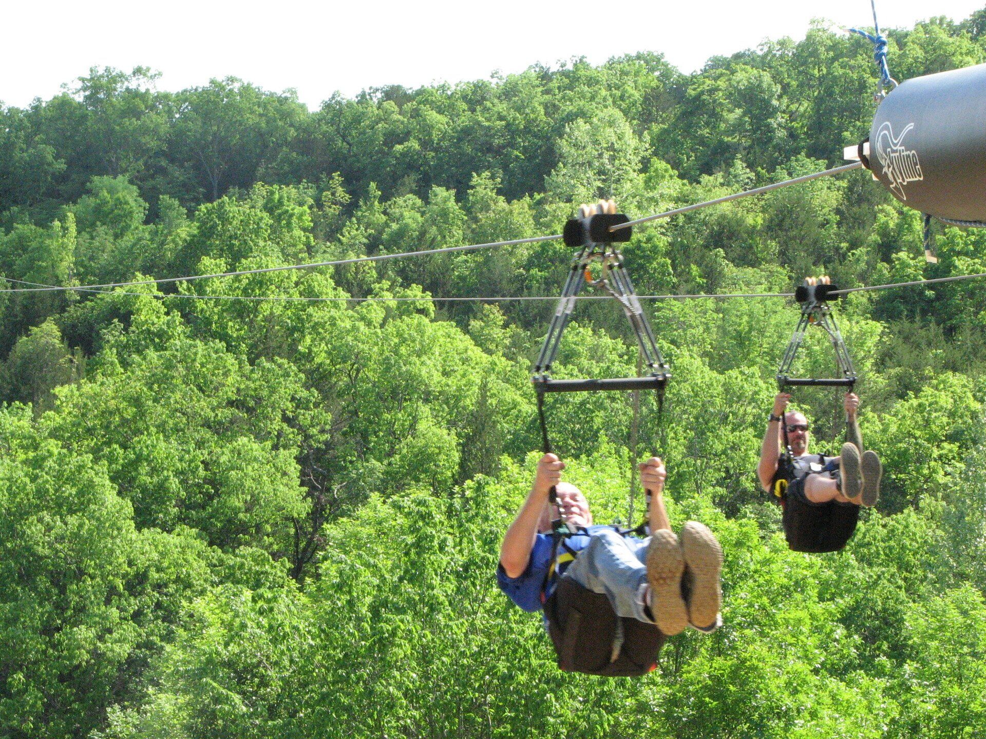 Two people riding on a Branson zipline