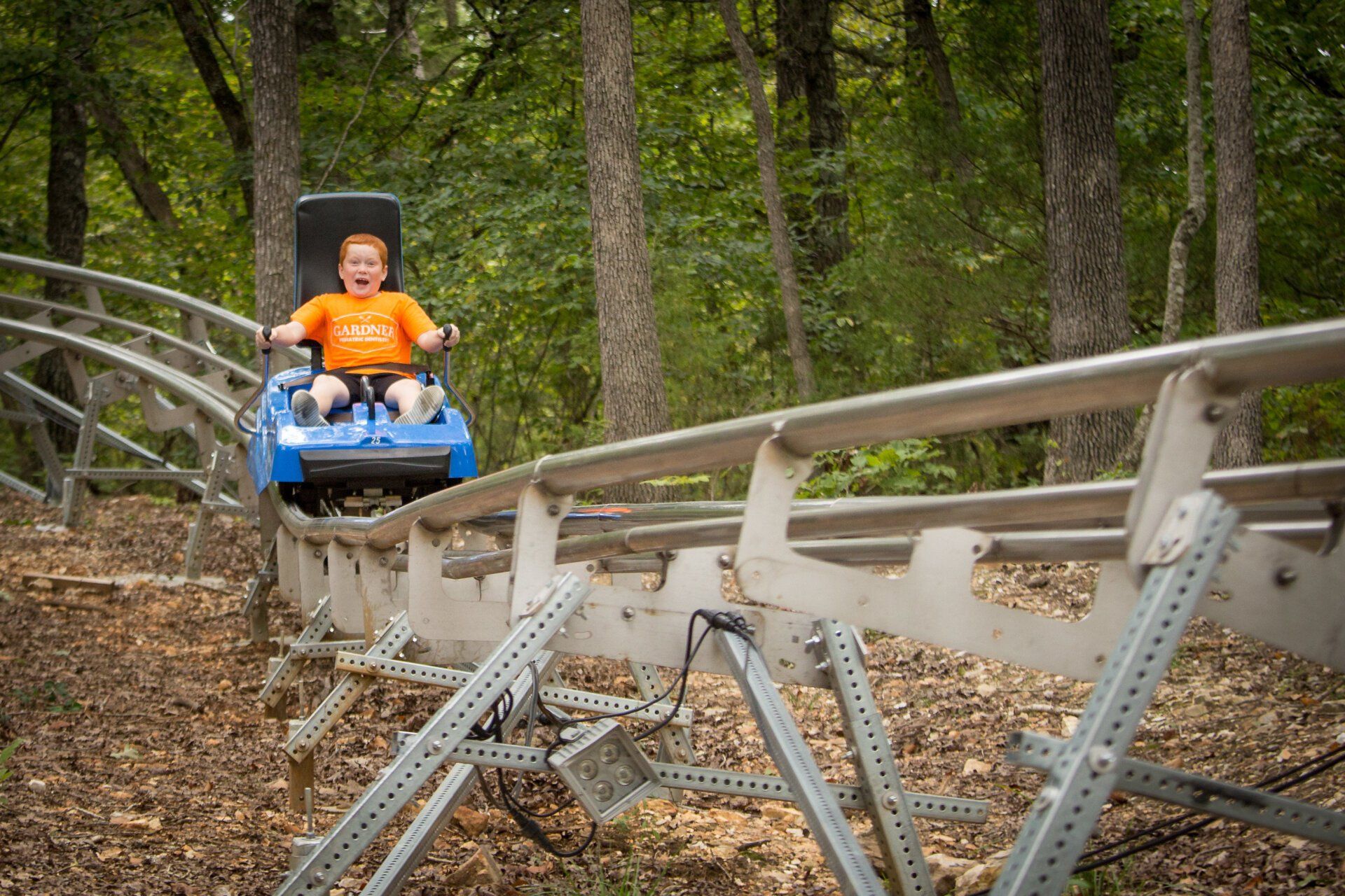 Child enjoying riding in coaster