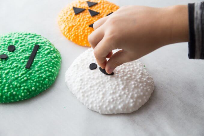 decorating ghost floam with black foam shapes