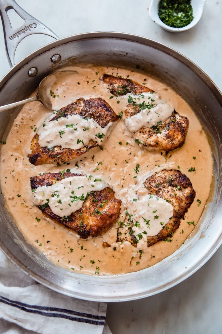 skillet with balsamic chicken on white marble