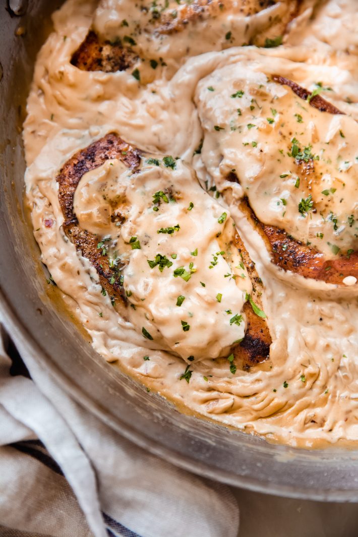 chicken covered in balsamic onion cream sauce in skillet