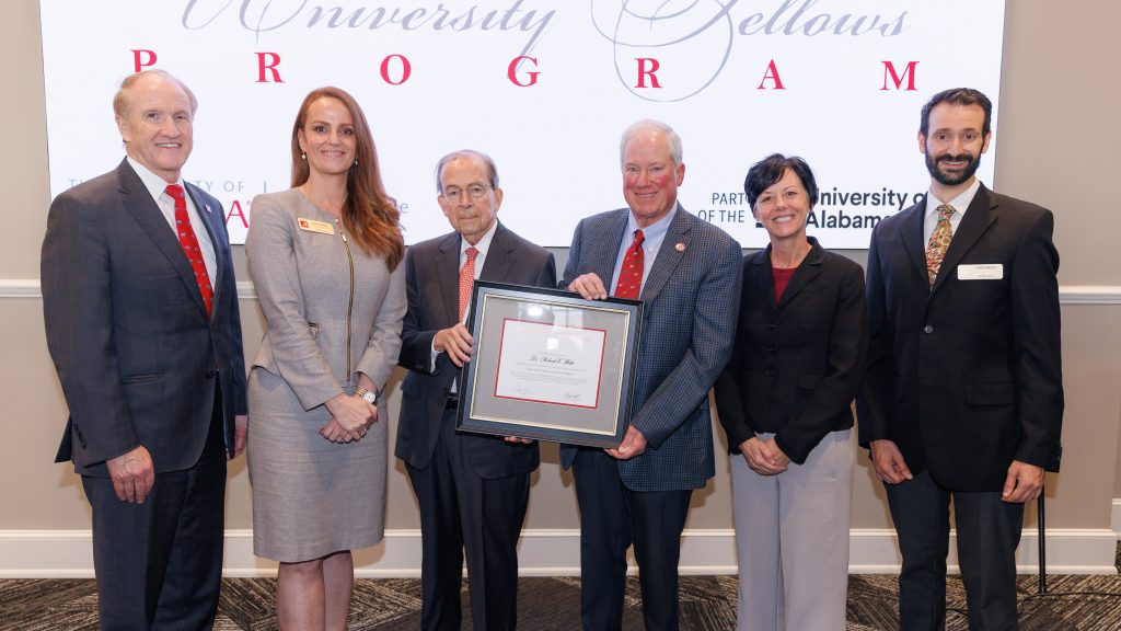 President Emeritus Robert Witt receiving a plaque from Dr. Allen Yeilding in honor of the renaming of the UA Fellows Program