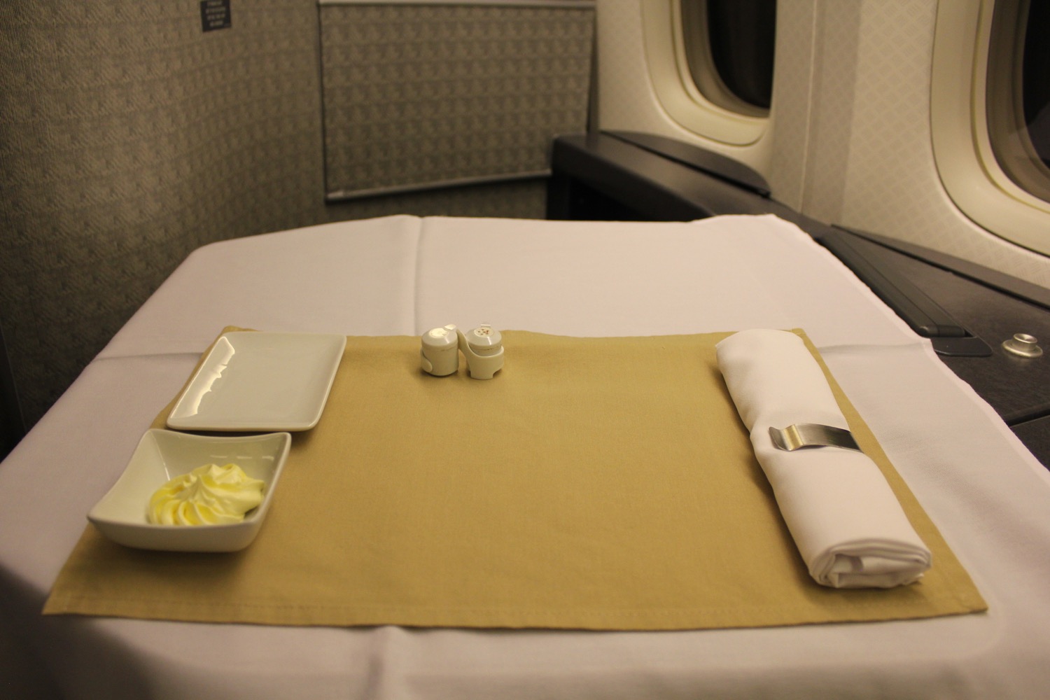 a table with a plate and napkin on it