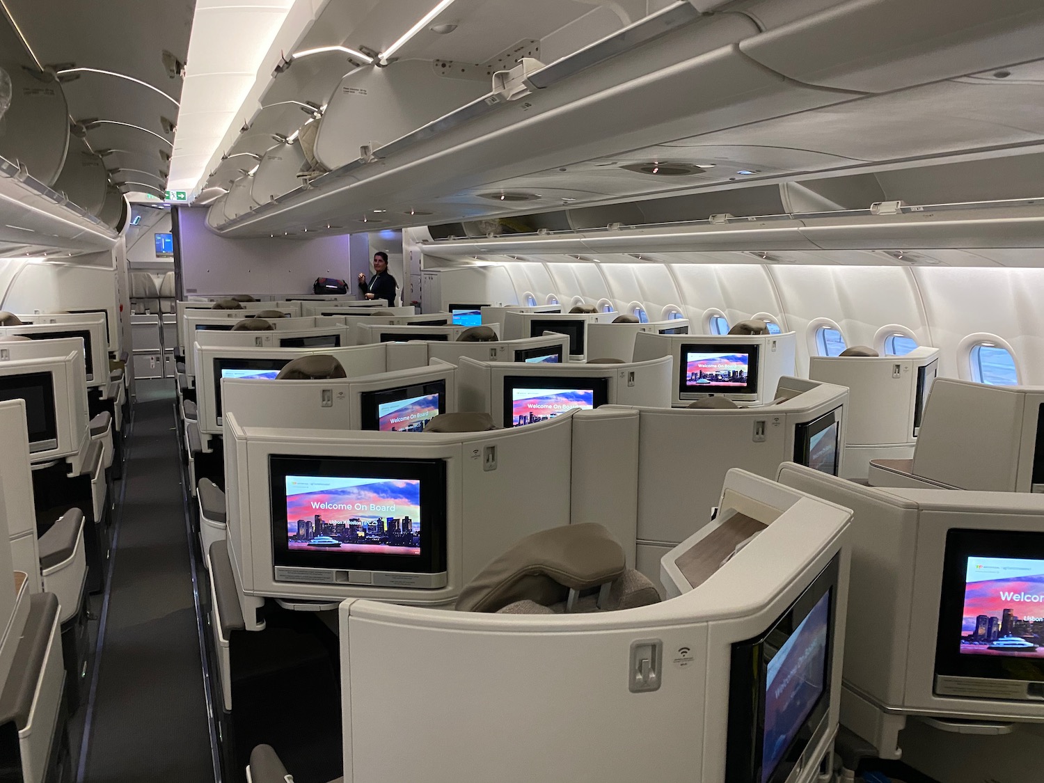 a row of seats with monitors on the side