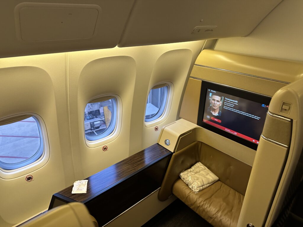 a seat and a television in an airplane