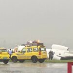 a group of yellow cars parked on a runway