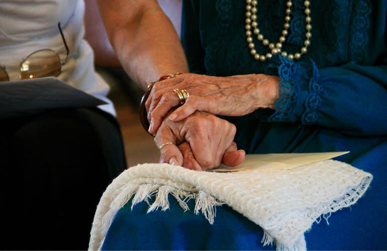 holding hands with elderly woman