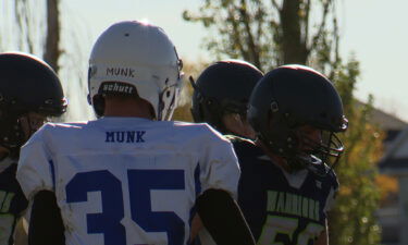 Rockland and Watersprings football players line up before a play.