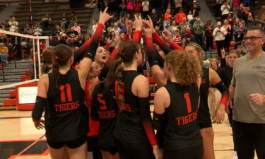 Idaho Falls Tigers volleyball players cheer after winning the district championship.