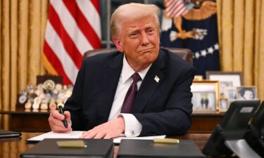 President Donald Trump signs executive orders in the Oval Office of the White House in Washington