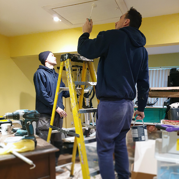 Team painting loft hatch door