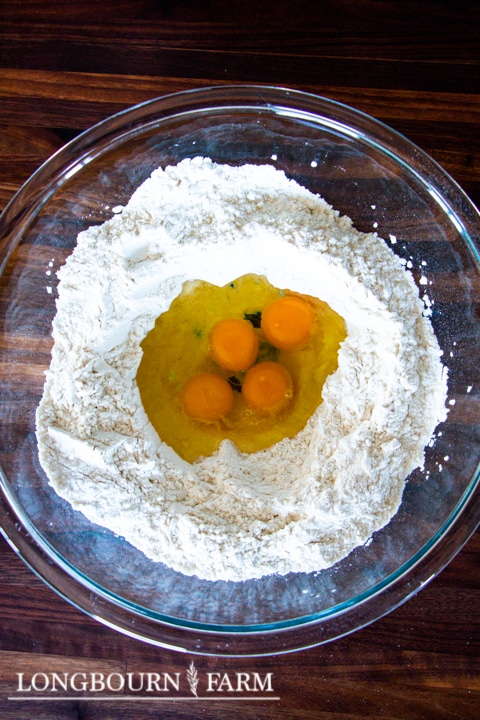 pasta dough flour mixture with eggs in a well in the center