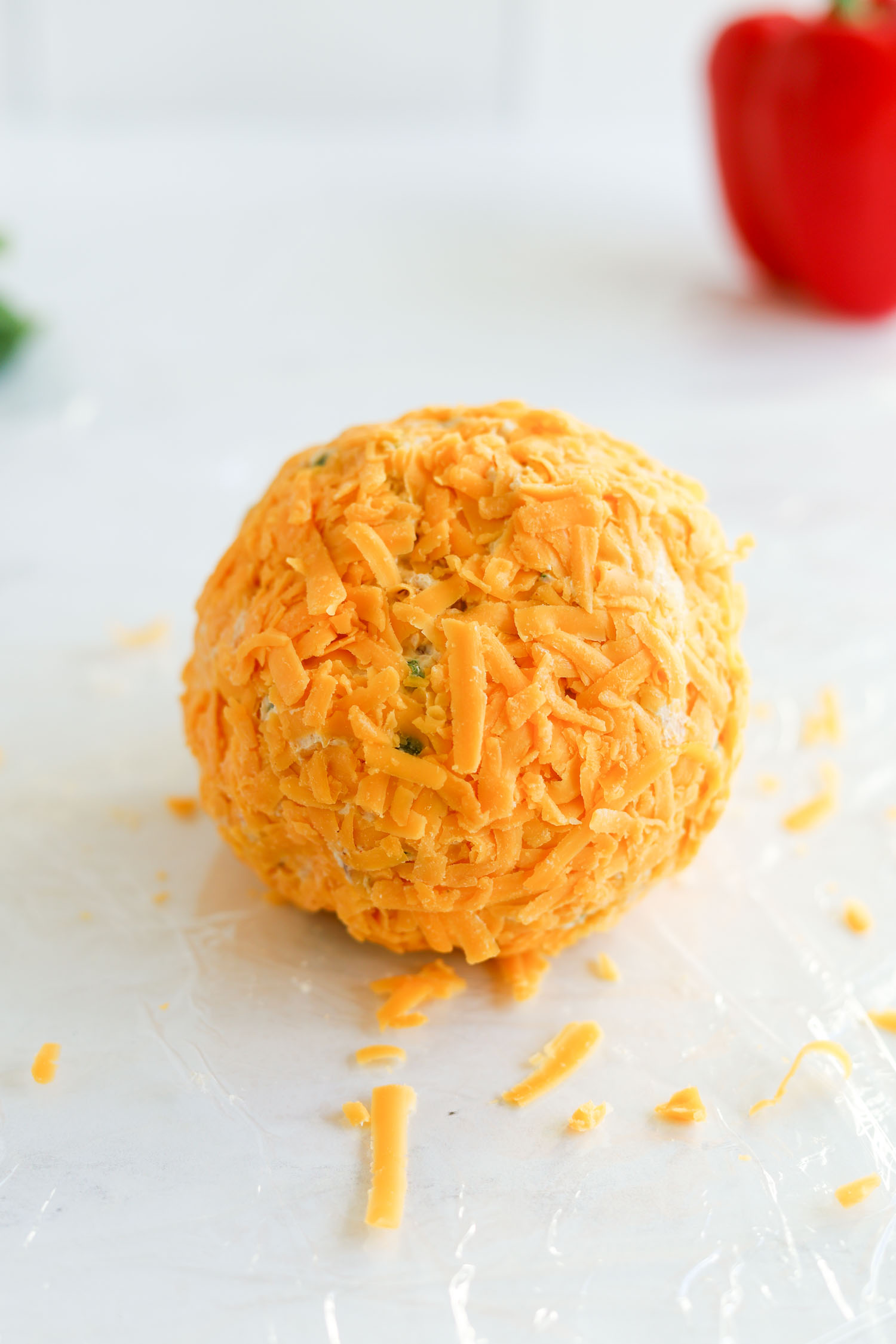 cheese ball rolled in sharp cheddar cheese