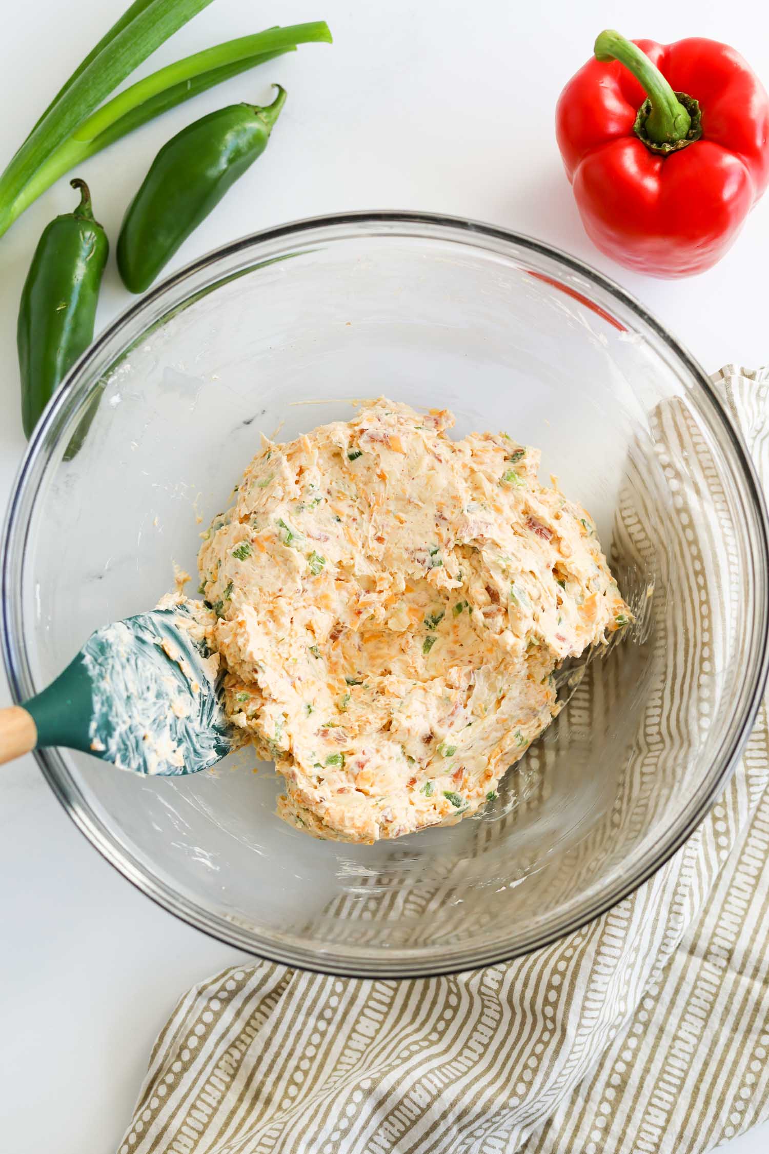 mixing together cheese ingredients with a spatula