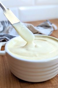 no salt mayonnaise recipe without sodium or preservatives blender mayo no salt recipe salt free mayonnaise in a dish with a knife about to spread it.