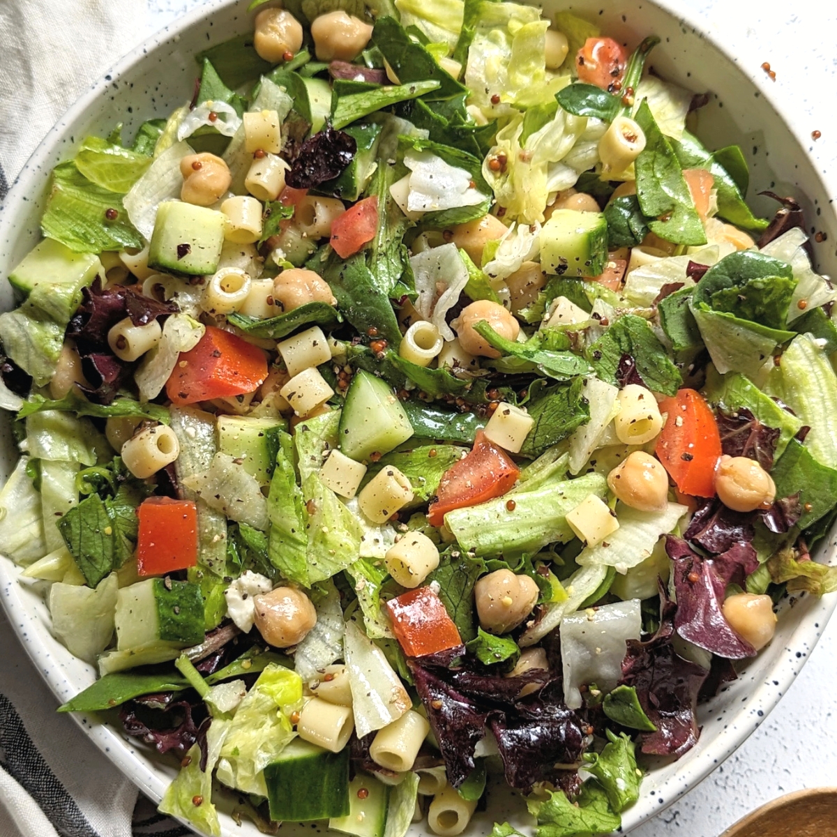 low sodium salad with tomatoes cucumber pasta chickpeas and a homemade dijon vinaigrette dressing