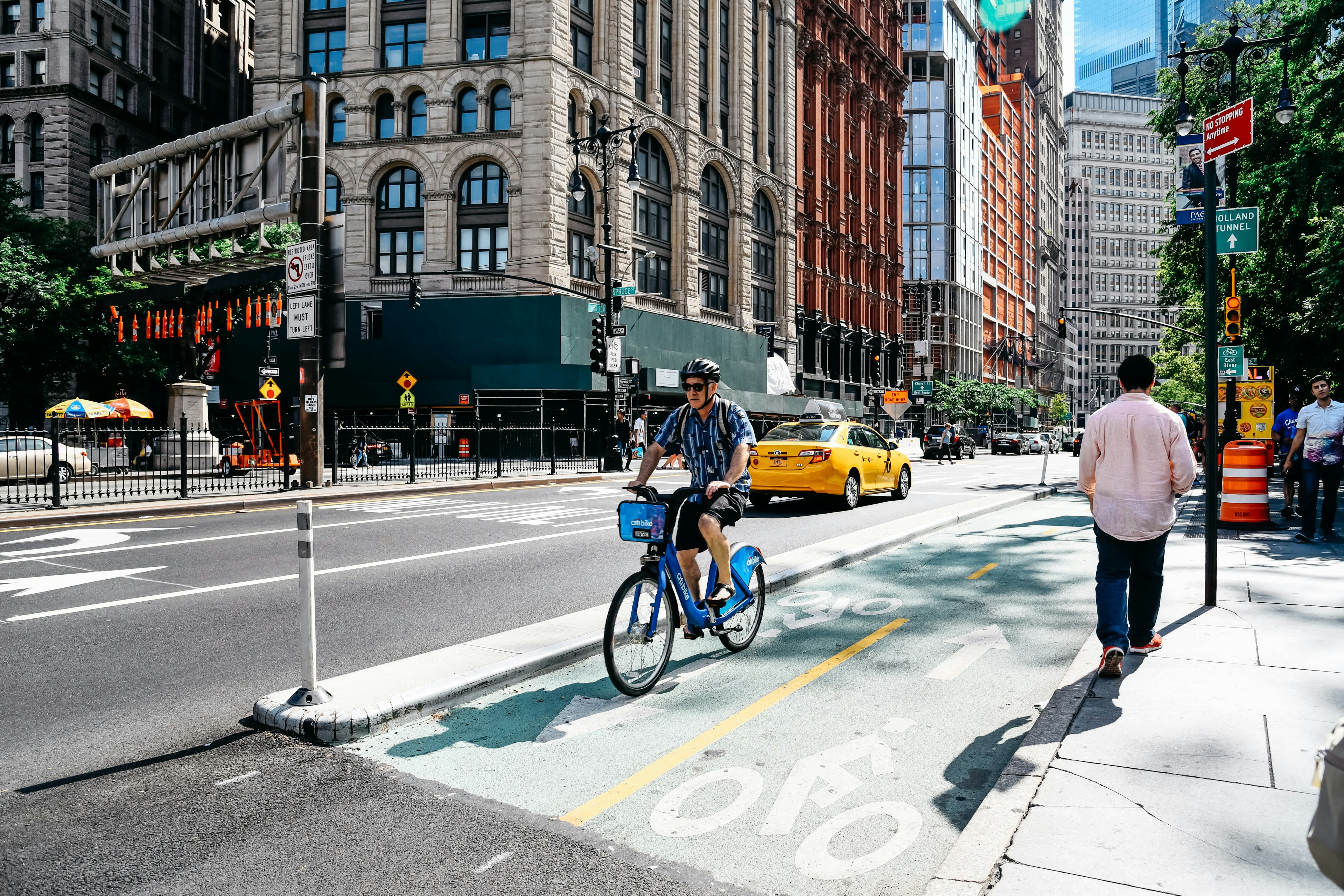 Cyclist riding in a bike lane at the Park Row financial district.