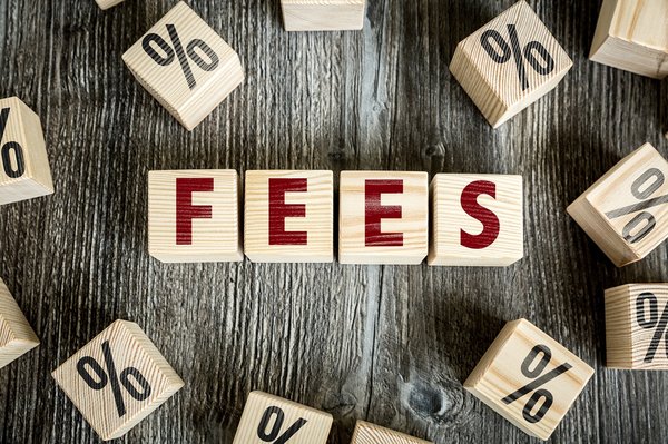 Blocks spelling out the word fees and surrounded by percentage signs.