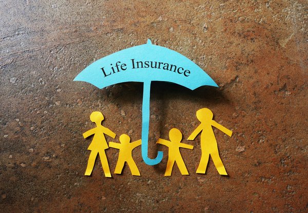 A paper cutout family under an umbrella that reads life insurance.