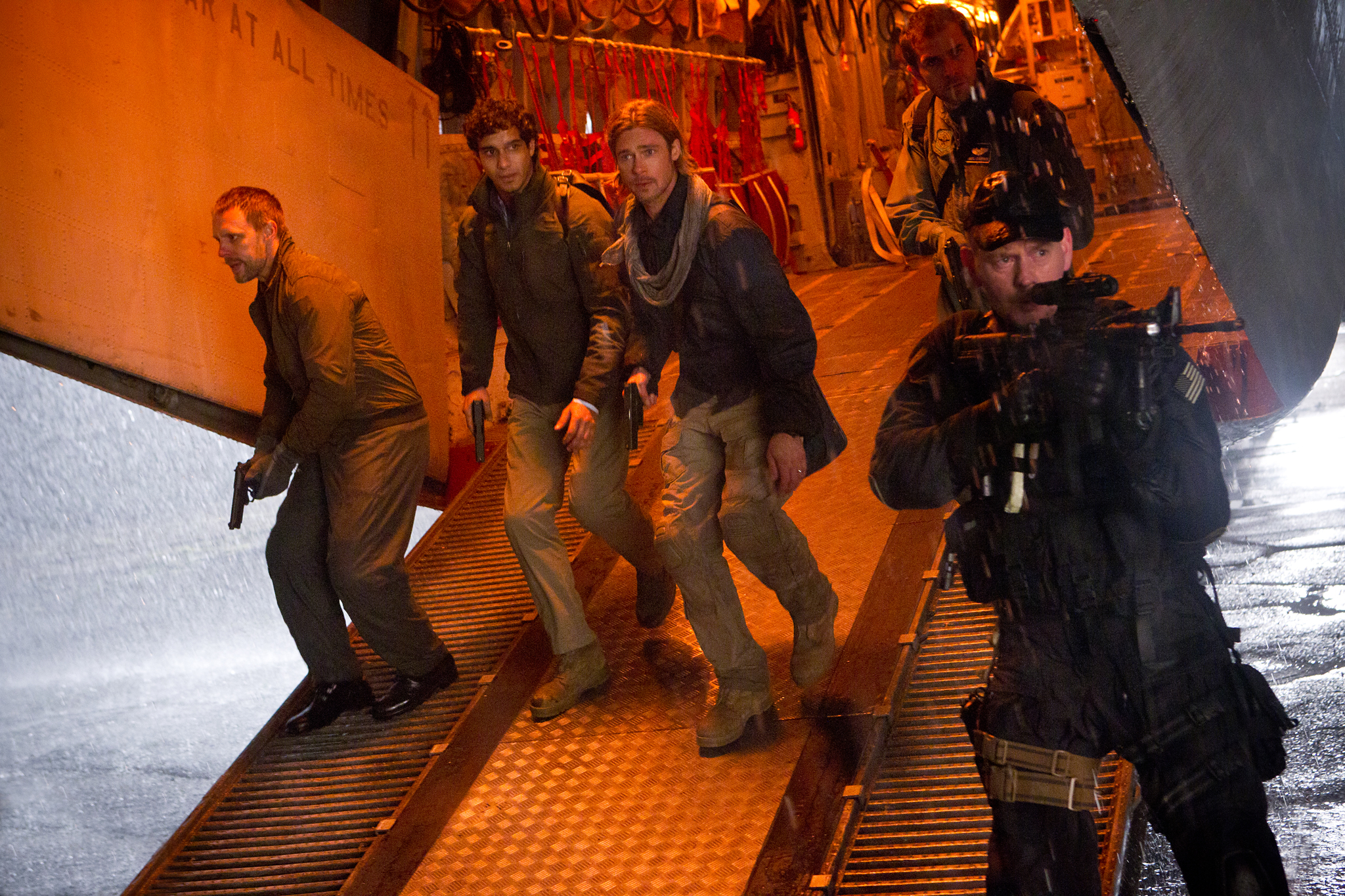 Brad Pitt, Grégory Fitoussi, John Gordon Sinclair, and Elyes Gabel in World War Z (2013)