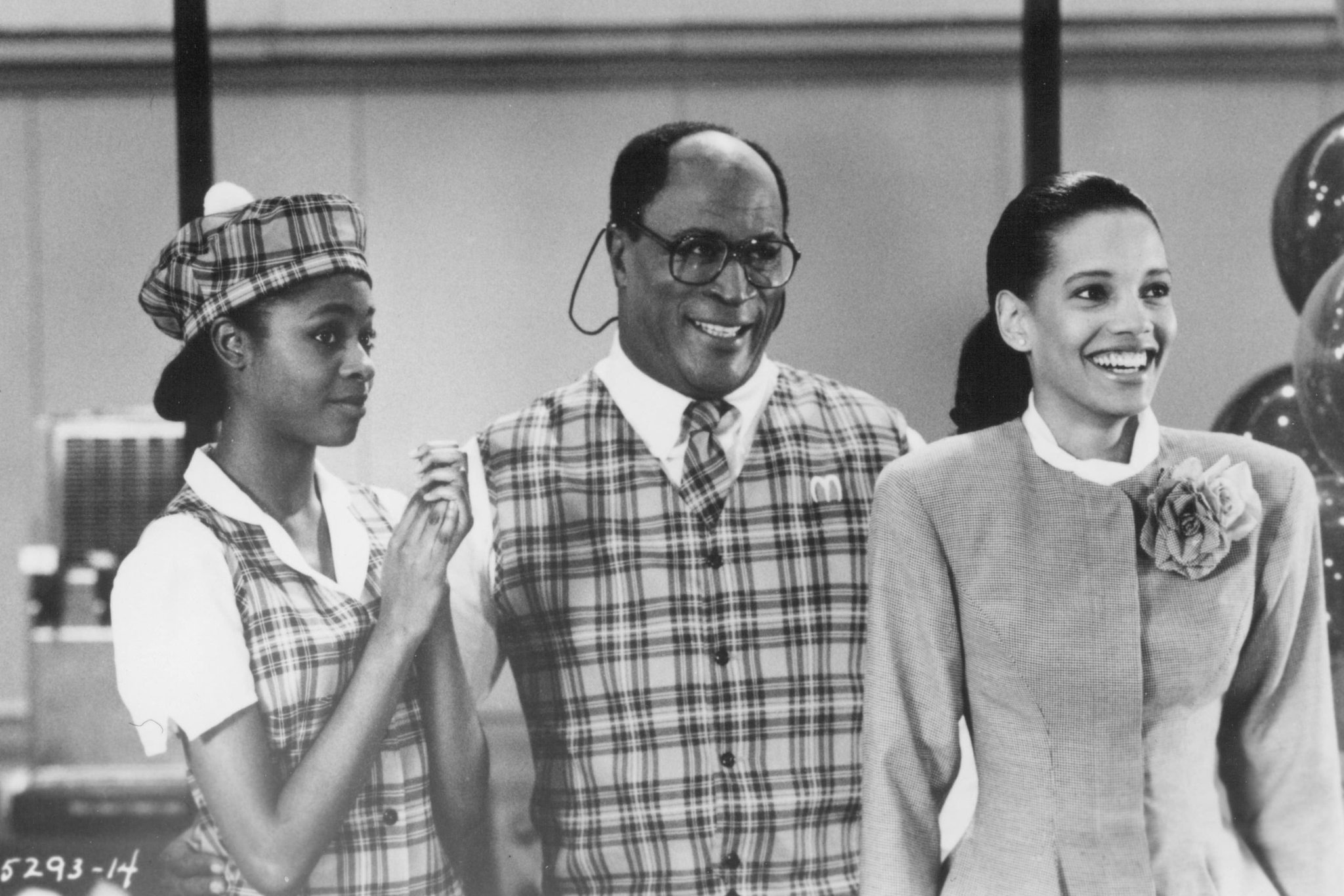 John Amos, Allison Dean, and Shari Headley in Coming to America (1988)