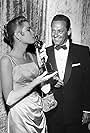 Best Actress Grace Kelly (The Country Girl) with presenter William Holden at the 27th Academy Awards.