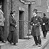 Charles Chaplin, Leota Bryan, and Eric Campbell in Easy Street (1917)