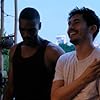 Parker Sawyers and Henry Golding in Monsoon (2019)